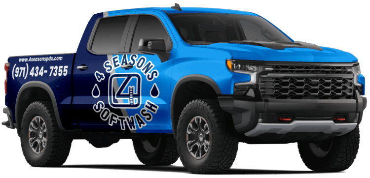 A blue and dark blue wrapped Chevrolet Silverado truck with "4 Seasons Softwash" and contact information on the side. A pressure washing service vehicle.
