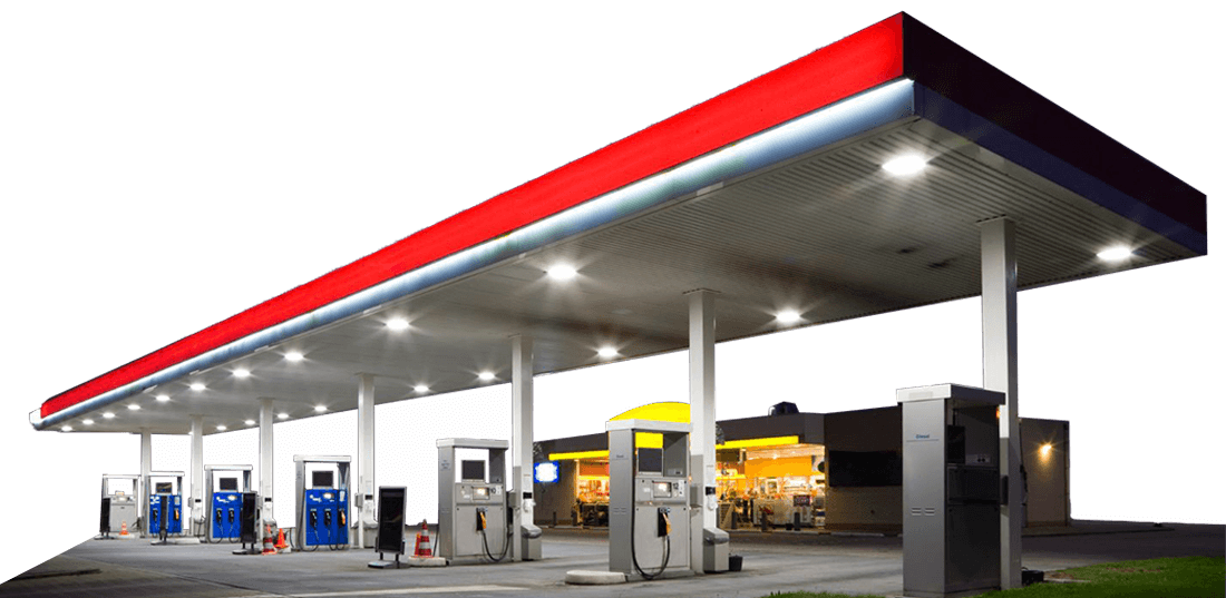 Well-lit gas station at night with red canopy, white support columns, and multiple pumps. Commercial power washing in Portland OR keeps stations like this clean and inviting.